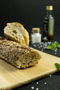 Rustic bread in a dark and wooden backgound 写真素材
