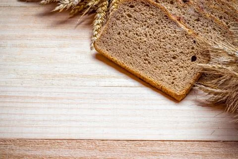 Rustic bread. Fresh loaf of rustic traditional bread with wheat grain ear or Stock Photos