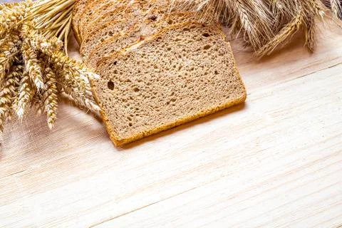 Rustic bread. Fresh loaf of rustic traditional bread with wheat grain ear or  Stock Photos