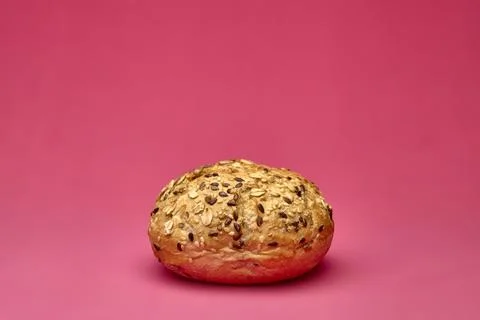 Rustic bread loaf with flour texture on pink background bakery photo Stock Photos