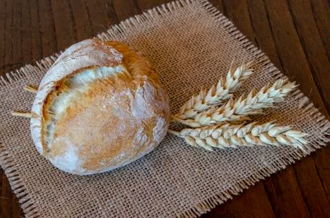 Rustic bread on wooden table Stock Photos