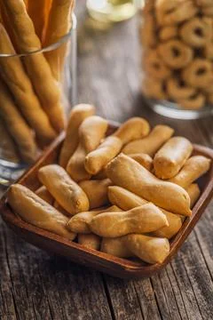 Rustic Breadsticks And Bite-Sized Savory Snacks In Wooden Bowl On Weathered.. Stock Photos