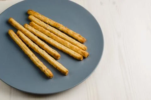 Rustic breadsticks in a dish on wood table, close up, background.. Stock Photos