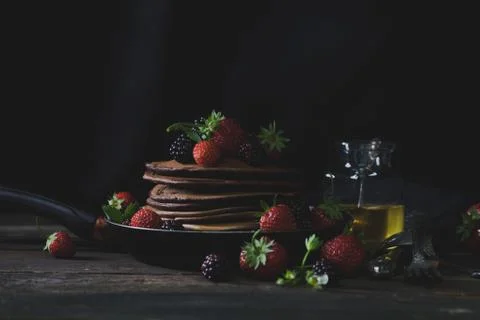 Rustic breakfast in the country side with pancakes and strawberries with hone Stock Photos