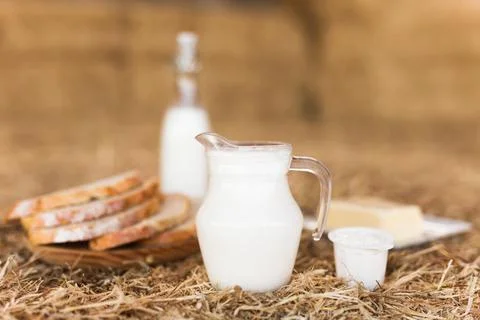 Rustic breakfast of milk, fresh wheat bread and butter in the hayloft Stock Photos