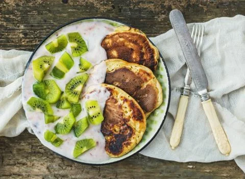 Rustic breakfast set with fluffy pancakes with strawberry yogurt Stock Photos