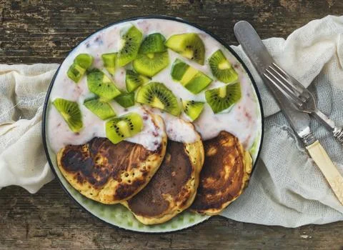 Rustic breakfast set with fluffy pancakes with strawberry yogurt Stock Photos
