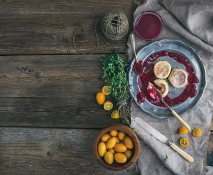 Rustic breakfast set. Russian cheese cakes on a vintage metal plate with ling Stock Photos
