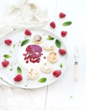 Rustic breakfast set. Russian cottage cheese cakes on a white ceramic plate w Stock Photos