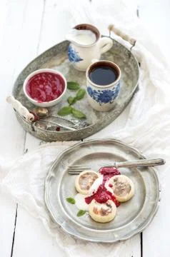 Rustic breakfast set. Russian cottage cheese pancakes or syrniki on a vintage Stock Photos