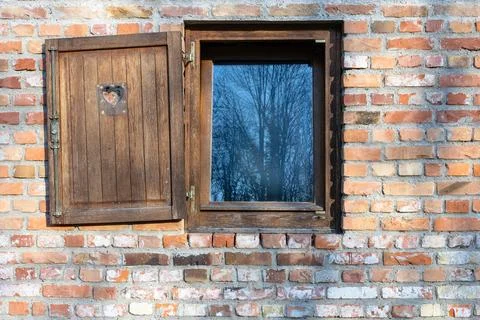 Rustic Brick Wall With  Wooden Shutter and Reflective Window Glass Showing .. Фото