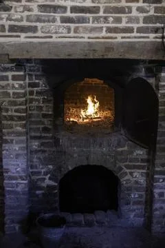 Rustic Brick Wood-Fired Oven With Glowing Fire and Traditional Baking Tools.. Stock Photos