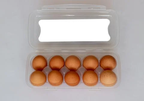 Rustic brown eggs in a plastic bag. Egg packaging on a white background Stock Photos