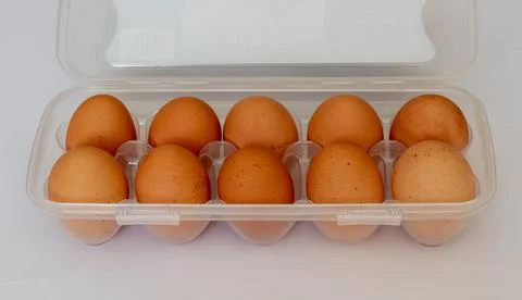 Rustic brown eggs in a plastic bag. Egg packaging on a white background Stock Photos