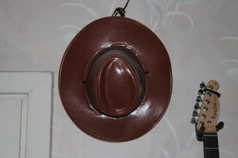 Rustic Brown Hat Hanging on Wall - Vintage Home Decor Stock Photos