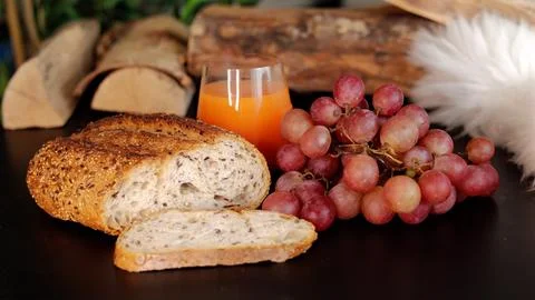 Rustic brunch spread with artisan bread, grapes, and fresh orange juice Stock Photos