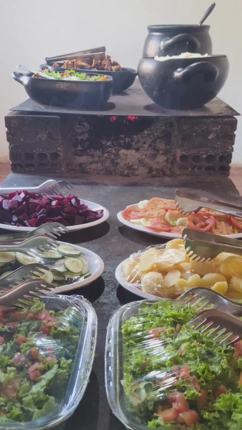 Rustic buffet with fresh salads and food on a wood-fired stove. 스톡 동영상 313240837