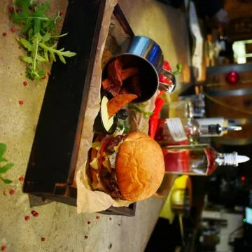Rustic burger with potatoes in a bar Stock Photos