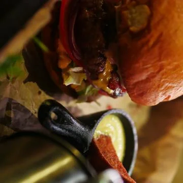 Rustic burger with potatoes in a bar Stock Photos