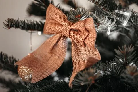 Rustic Burlap Bow on Christmas Tree with Twinkling Lights Stock Photos