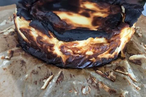 Rustic Burnt Basque Cheesecake on Parchment Paper - Baking Inspiration Stock Photos