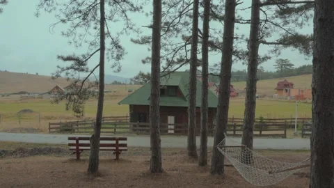 Rustic Cabin and Swing Set in Zlatibors Peaceful Countryside Stock Footage 295215257
