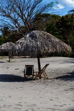 Rustic cabin with chairs in beach Stock Photos