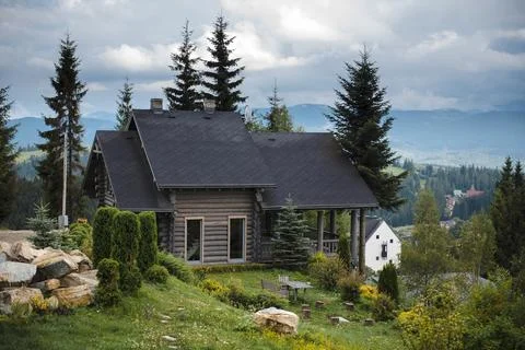 Rustic Cabin in Mountainous Landscape Stock Photos