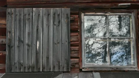 Rustic cabin wall with shutter and reflective window. Stock Footage 318196219
