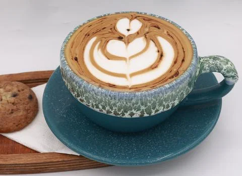 Rustic cafe scene featuring a cappuccino with stunning heart-shaped latte art Stock Photos