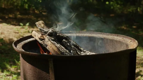 Rustic Campfire Burning Inside a Metal Fire Pit Outdoors in Forest 動画素材 342378490