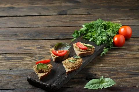 Rustic Canapes with Savory Spread and Fresh Vegetable Toppings 写真素材