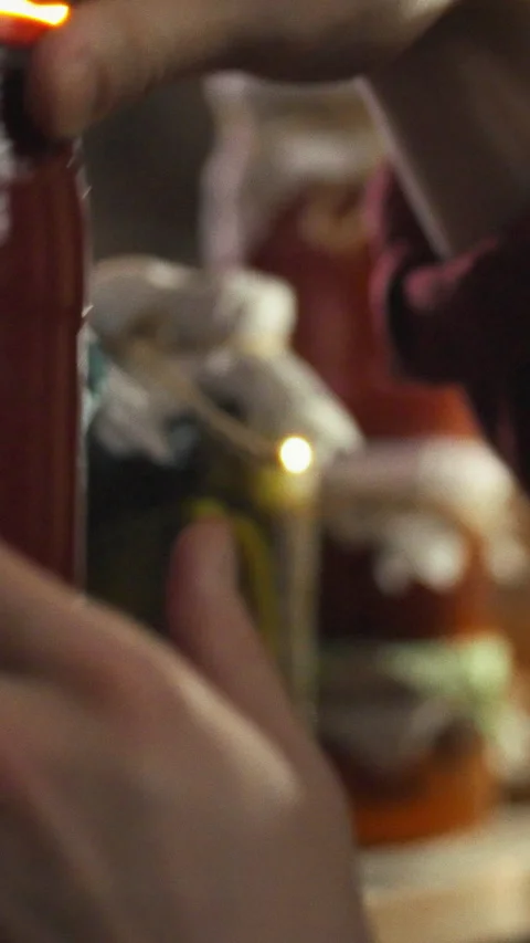 In rustic cellar man examines rows of jars filled with fermented vegetables Stock Footage 334394992