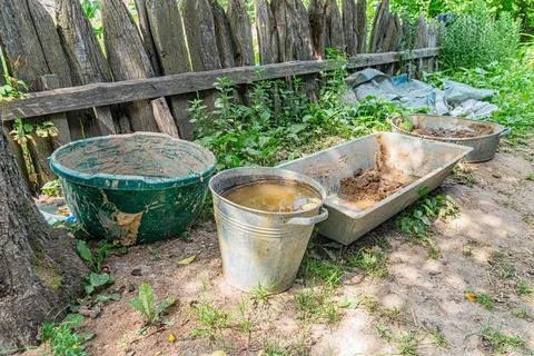 Rustic Central European village setting, featuring soil-filled containers buc Stock Photos