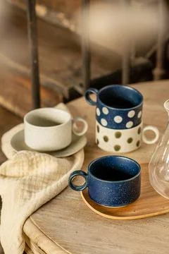 Rustic Ceramic Coffee Cup Set with Polka Dot Pattern on Wooden Table Stock Photos