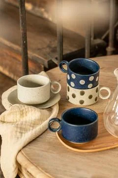 Rustic Ceramic Coffee Cup Set with Polka Dot Pattern on Wooden Table Stock Photos
