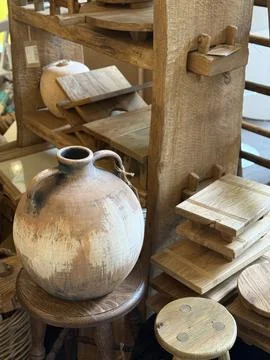 Rustic ceramic jug displayed among wooden kitchenware in a cozy, natural se.. Stock Photos