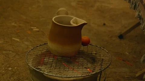 Rustic ceramic pitcher heating up for a warm drink. Stock Footage 328617522