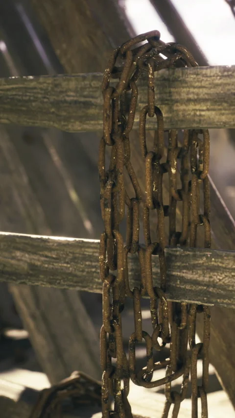 Rustic chain drapes by weathered planks in soft sunlight Stock Footage 331806797