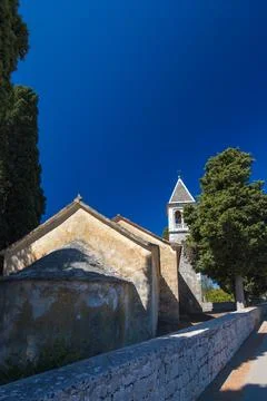 Rustic Chapel Amid Cypress Trees under Bright Blue Sky, Donje selo, Solta Stock Photos