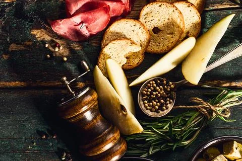 Rustic charcuterie board with cheese bread and spices Stock Photos