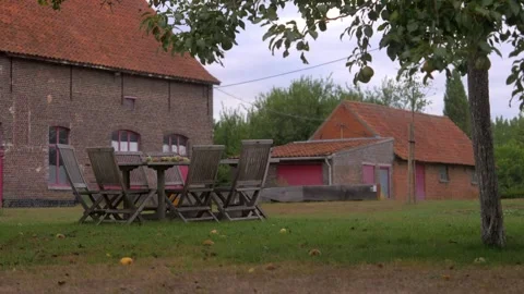 Rustic Charm: Al Fresco Dining in Vintage Belgian Farm Stock Footage 253036412