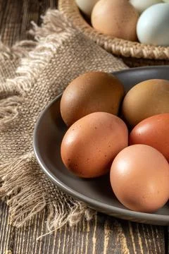 Rustic charm: organic chicken eggs gathered from home farm on wooden table Stock Photos