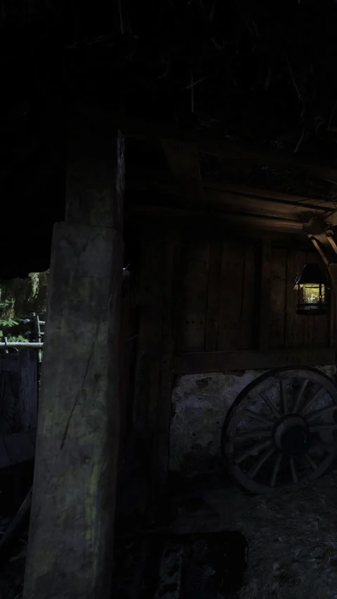 Rustic charm shines through an old wooden barn at night with a glowing lantern Stock Footage 340079926