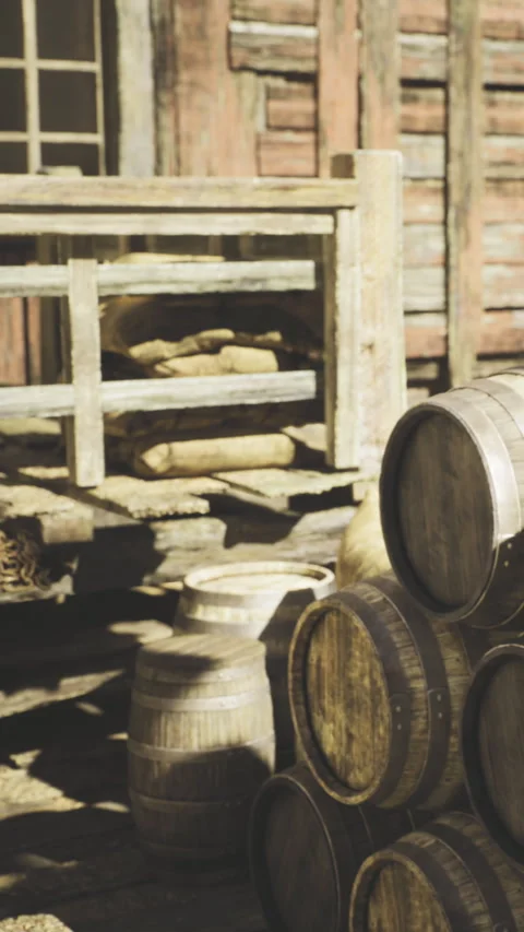 Rustic charm of a weathered barn with barrels and sacks in warm sunlight Stock Footage 331807054