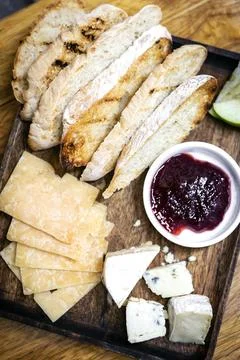 Rustic cheese board platter with bread and redcurrant jam Stock Photos