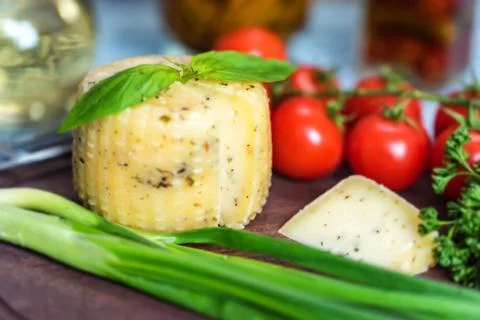 Rustic cheese with herbs and vegetables Stock Photos
