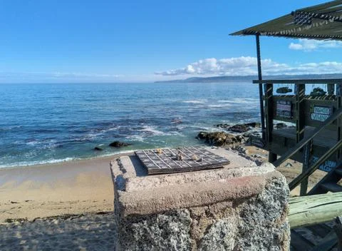 Rustic chess game on the seashore Stock Photos