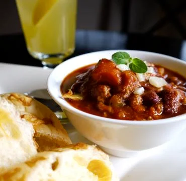 Rustic Chili with cheese bread on white plate Stock Photos