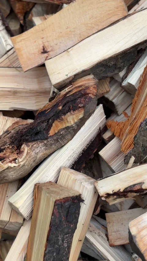 Rustic chopped logs stacked together for fireplace heating Video stock 336260243